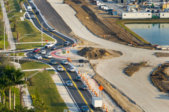 Roundabout construction roadworks on American transport infrastructure. Renovation of highway road with moving traffic. Development of interstate transportation concept