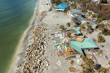 Storm surge caused by hurricane wind severe damaged residential houses on ocean shore. Natural...