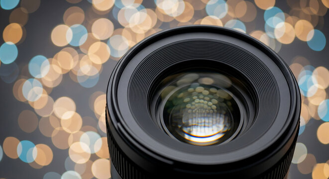 Close-up of camera lens with light bokeh in background symbolizing photography and optical focus