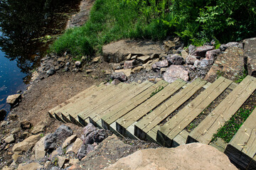 stairs leading down a riverbank to assist with erosion control with riprap on the sides....