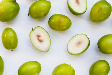 Green jujube fruits on white background.