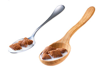 chocolate pillows with milk in a metal spoon isolated on white background.