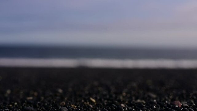 Blur of waves crushing on a black pebble beach. Hvalnes Nature Reserve Beach in Iceland 