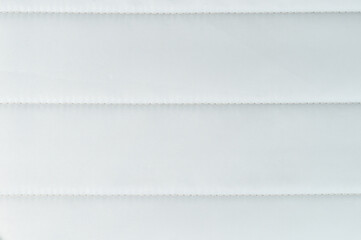 White textured fabric with defined stitching showing smooth and elegant lines