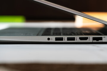 Close up detail of the side panel connectivity on a modern laptop, showing various input and output...