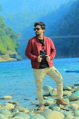 A man was standing near a Lake