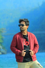 A man was standing near a Lake