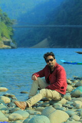 A man was standing near a Lake