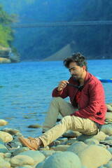 A man was standing near a Lake