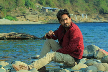 A man was standing near a Lake