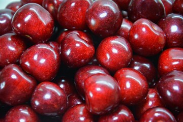 Tightly packed ripe cherries with matte skin and natural imperfections captured in close detail for food realism, authentic fruit imagery, and organic produce representation