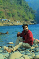 A man was standing near a Lake