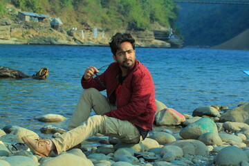 A man was standing near a Lake