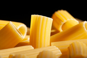pasta rigatoni macro closeup detail on black