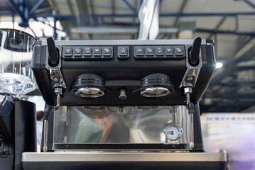 Front view of espresso machine with portafilters and control panel
