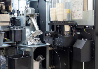Inside view of automated coffee vending machine with cup dispenser system