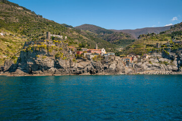 The seaside village of Monterosso al Mare, Cinque Terre, is known for its colorful buildings nestled between terraced cliffs above the blue waters of the Ligurian Sea.
