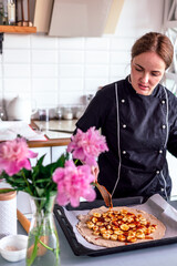 Close up view of baker is working. Homemade pie. Hands preparing dough on table. 