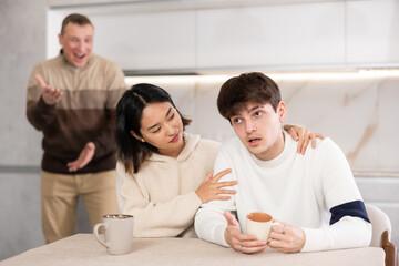 Domestic quarrel between relatives - father scolds and shouts at a married couple