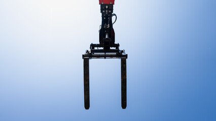 Telehandler construction lift forks lifted up in the air for material handling for reach and maneuverability in modern construction industry