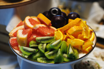 Plate with sliced fresh fruits