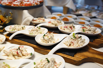 Squid and herb salad served in spoons on the table