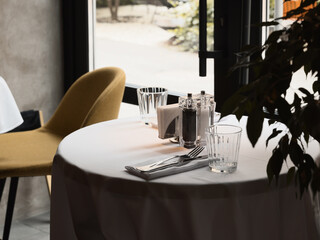 An Elegant Dining Table Setting within a Modern Restaurant that Enhances a Welcoming Atmosphere