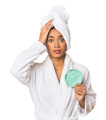 Young Filipino woman with alarm in bathrobe being shocked, she has remembered important meeting.