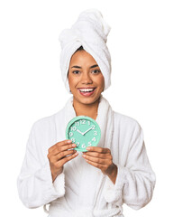 Young Filipino female in robe with alarm, happy in studio