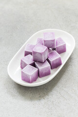 Cute Black Grape ice cream in the form of small cubes. On a plate