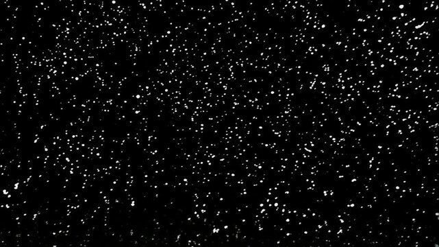 Dense pattern of white dots scattered on a black background suggesting stars or particles moving randomly with depth