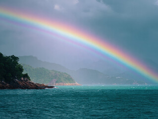 Impressive rainbow arcs over a vibrant sea landscape