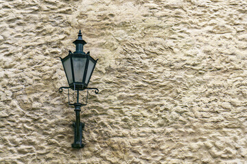 Old street lamp on a medieval wall