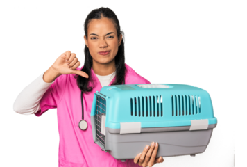 Young Filipina vet holding pet carrier showing a dislike gesture, thumbs down. Disagreement concept.