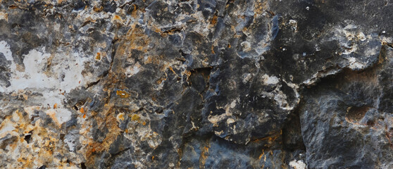 Aged rocky formation featuring textured layers Shadowy surfaces