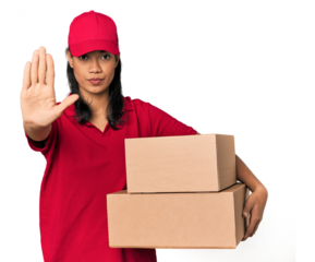 Young Filipina courier with two packages standing with outstretched hand showing stop sign, preventing you.