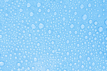 Water Drops on Blue Surface. Freshness and Clean Texture Background. Stock photo.