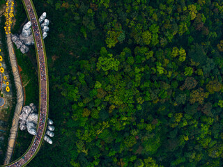Aerial top view of golden bridge at ba na hills in lush Da nang, Vietnam