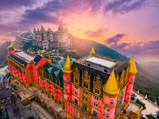 Stunning sunset at ba na hills castle, Da nang, colorful touristic architecture and scenic landscape