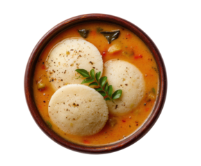 Flavorful Indian dish with steamed rice dumplings in savory sauce on a transparent background, cut out