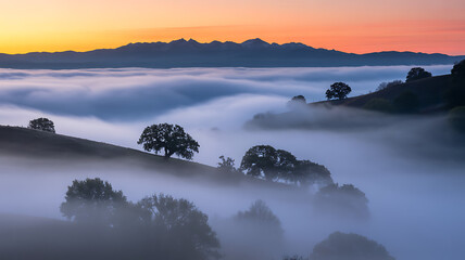 Misty Sunrise over Mountain Range and Rolling Hills