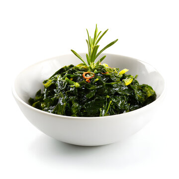 Minimalist presentation of callaloo in a simple white bowl with herb garnish on a pure white background