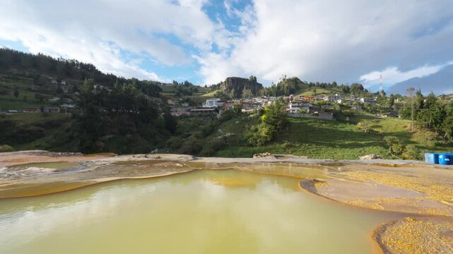 Salt mines reflecting clouds and sky in the town of Salinas de Guaranda in the Bolivar province of Ecuador