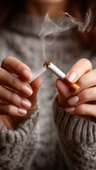 Woman decisively breaks a cigarette in a moment of determination
