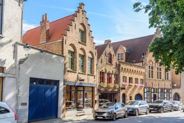 Traditional brick buildings and shops along a cobbled street in a city centre on a sunny summer day