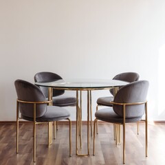Glass-topped round dining table with four grey velvet chairs on gold metal frames, minimalist setting