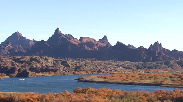 LTR pan of the Colorado River near Needles, California showing the volcanic needle formations on the Arizona side.