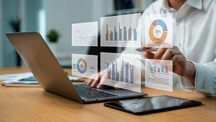 Person using laptop interacts with holographic data charts graphs business analytics visualization