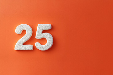 Chiffres blancs texturés formant le nombre 25 sur fond orange vif avec espace négatif à droite pour design graphique ou communication visuelle
