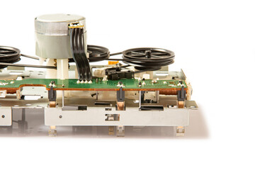 old stereo tape recorder magnetic tape rewind mechanism on white background. Close-up. Copy space